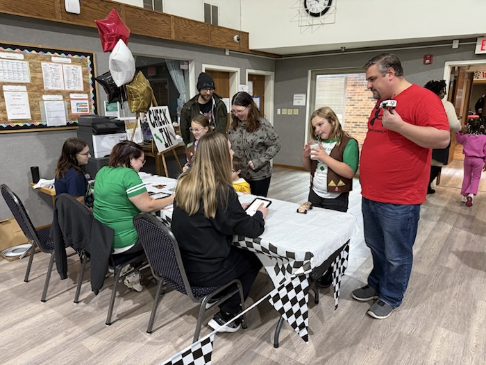Scouts and volunteers gathered at the check-in table.