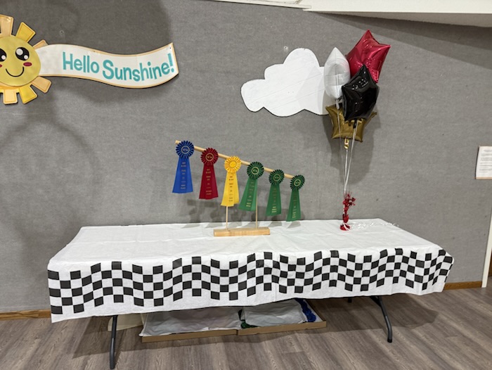 Award ribbons displayed above a checkered table.